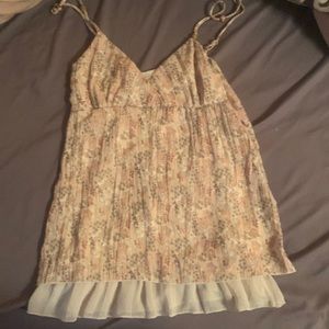Peach and cream colored pattern with sparkles on a babydoll cut tank top